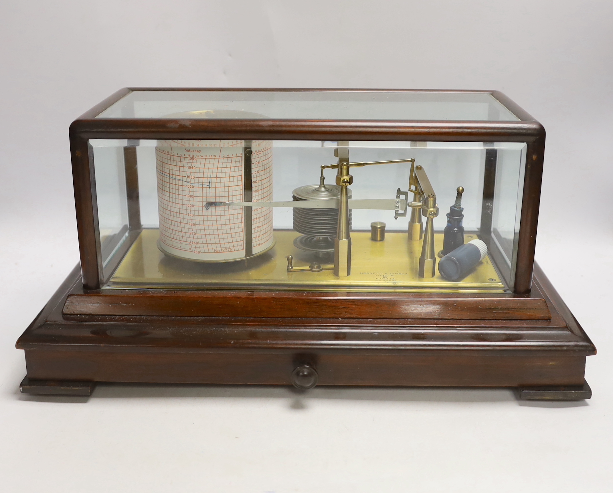 An early 20th century Negretti & Zambra barograph, engraved ‘made in England’, in a mahogany case, with drawer below, 42cm wide